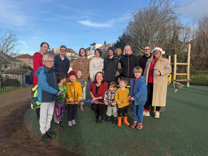 Local residents including children join Cllr Heather Mack as she cuts the ribbon at the new South Purdown play area